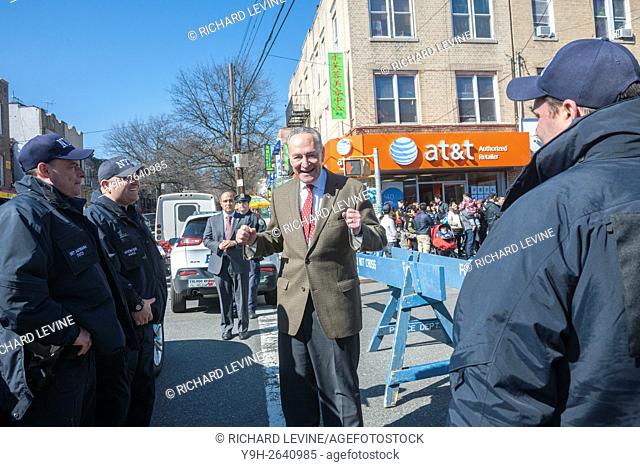 NY Senator Charles Schumer greets police officers Eighth Avenue in the Sunset Park neighborhood in Brooklyn in New York during the Lantern Festival street fair