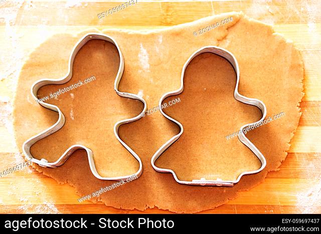 Cooking and decorating christmas gingerbread. Gingerbread man mould. Gingerbread man and his wife. Gingerbread in the shape of a stylized human and other shapes