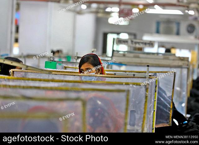 Preventive measures are put into place whilst manufacturing clothes in a garment factory during the resuming of activities for industries amid Covid-19...