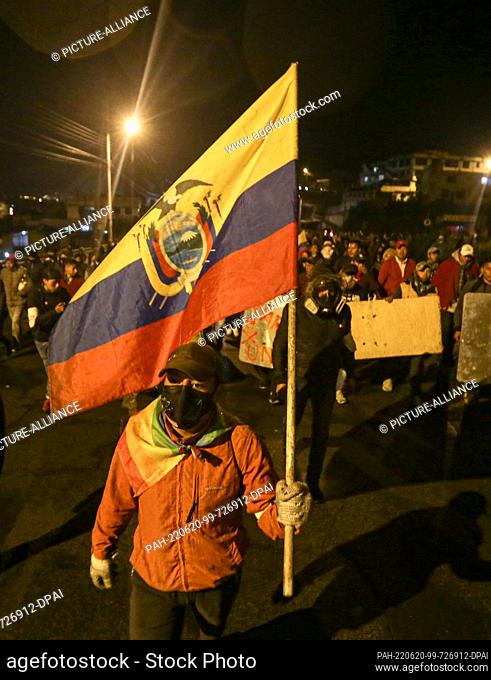 19 June 2022, Ecuador, Quito: On foot, a community leader leads the march of hundreds of indigenous people from the province of Cotopaxi along the E35 highway...