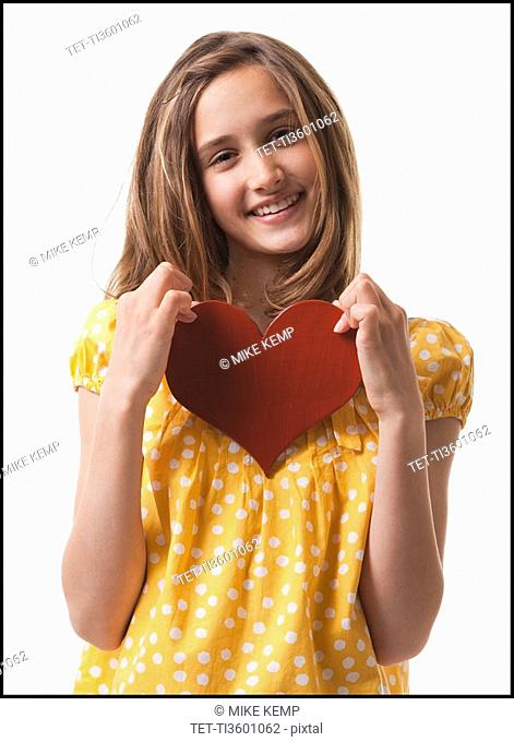 Teenage girl holding heart