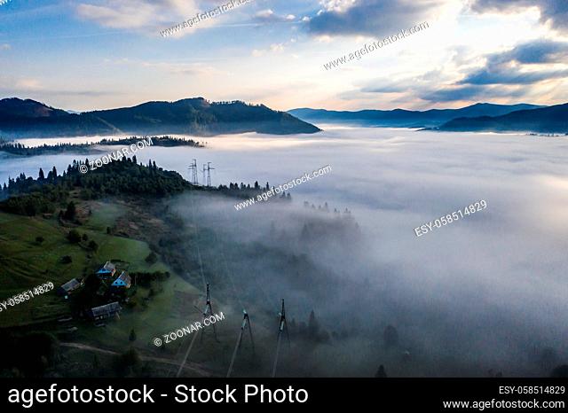 Aerial view of colorful mixed forest shrouded in morning fog