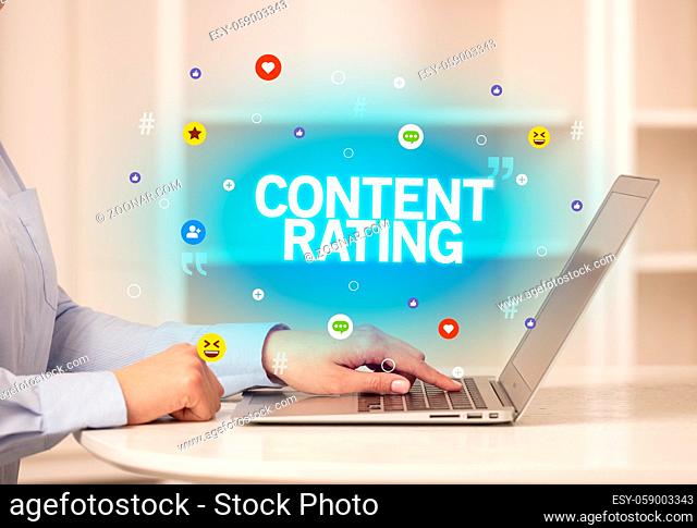Freelance woman using laptop with CONTENT RATING inscription, Social media concept