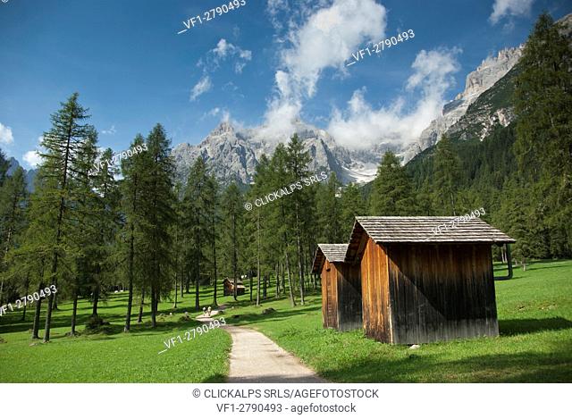 In the forest of firs crossed by the trail of the Fondovalle are many wooden small houses for tools. Fischleinvalley, Trentino Alto-Adige, Italy