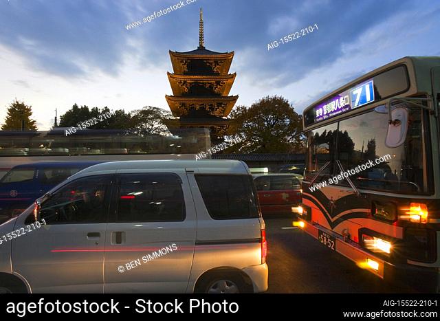 A twilight view shows traffic on Omiya Avenue passing by Toji Temple's wooden five-storied pagoda (the tallest wooden tower in Japan), located in central Kyoto