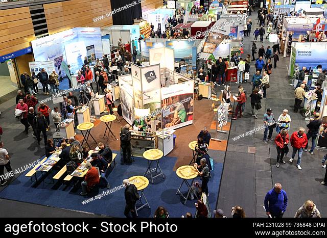 28 October 2023, Thuringia, Erfurt: Visitors stand at the fair ""Travel & Caravan 2023"". 315 national and international exhibitors present themselves and...