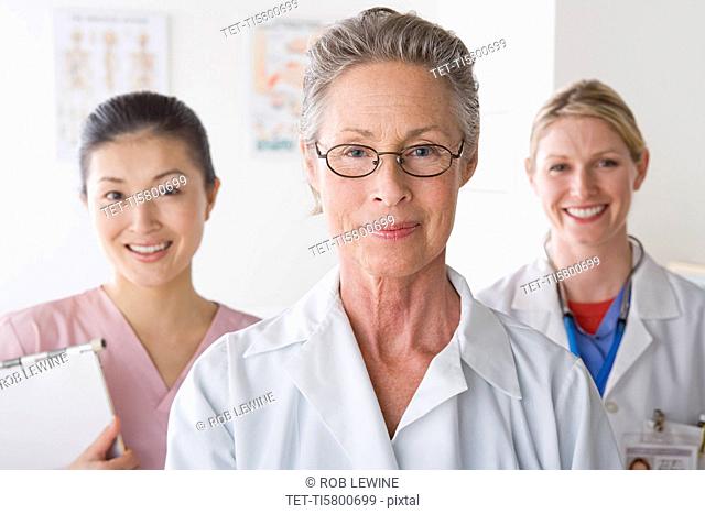 Portrait of three smiling female doctors