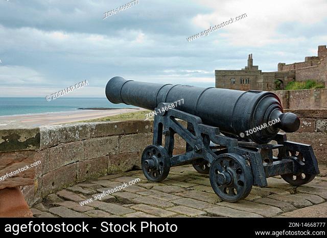 BAMBURGH, NORTHUMBERLAND, ENGLAND, UK - SEPTEMBER 10, 2017: Old Iron Cannon at Bamburgh Castle on Northumberland Coast of England, UK