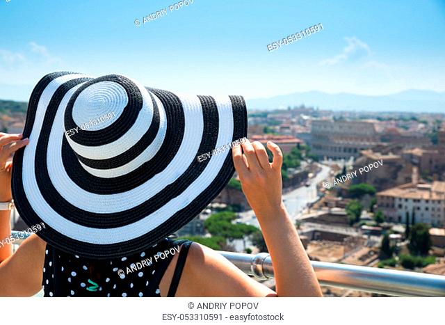 Rear View Of Female Tourist Looking At Roman Forum And Colosseum