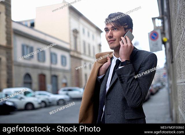 Portrait of young businessman on the phone