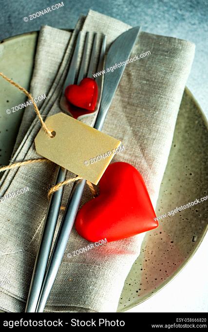 Cutlery set with hearts on stone background with copy space