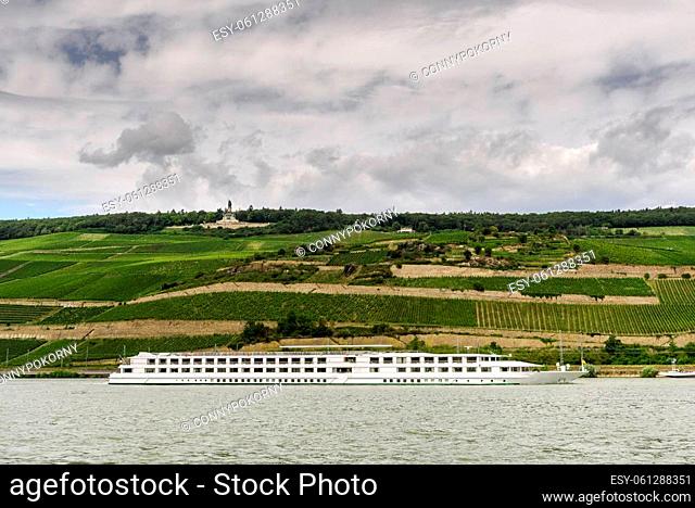 View over the Rhine to the Niederwalddenkmal (Niederwald monument) and surrounding vineyards, cruise ship in the foreground