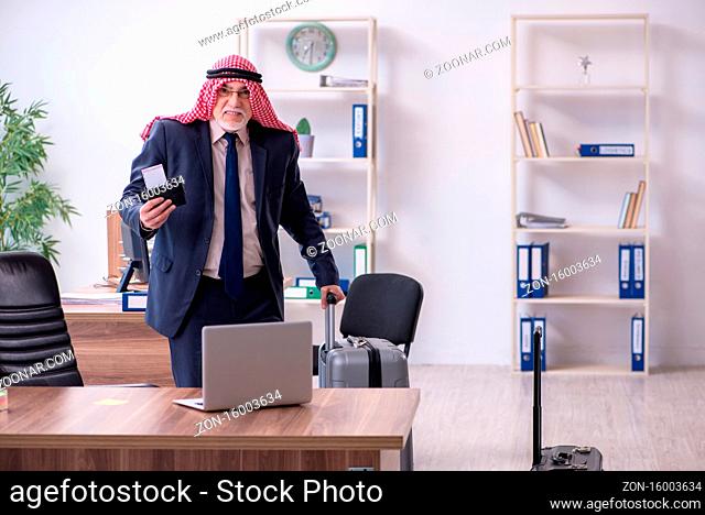 Old arab businessman preparing for the business trip