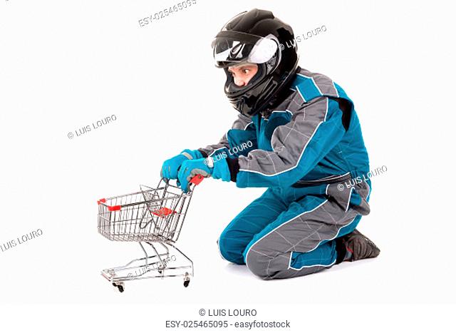 Racing driver posing with shopping cart isolated in white