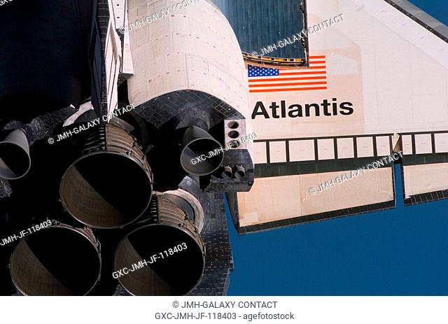 A crewmember aboard the International Space Station took this picture with a handheld digital still camera as the Space Shuttle Atlantis performed a backflip...