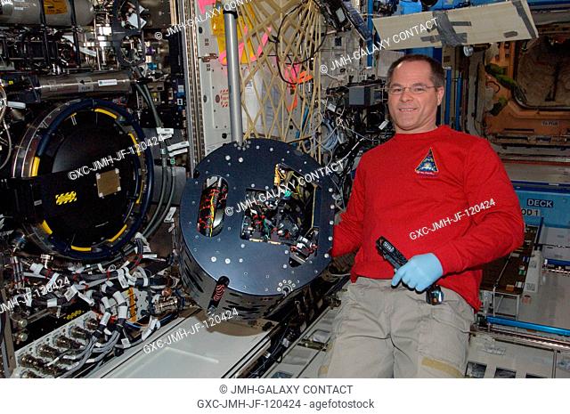 NASA astronaut Kevin Ford, Expedition 34 commander, performs in-flight maintenance on the Combustion Integrated Rack (CIR) Multi-user Droplet Combustion...