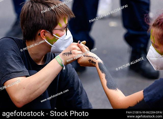 16 August 2021, Berlin: Activists, including the environmental group Extinction Rebellion, protest the government's environmental policies with a sit-in on the...