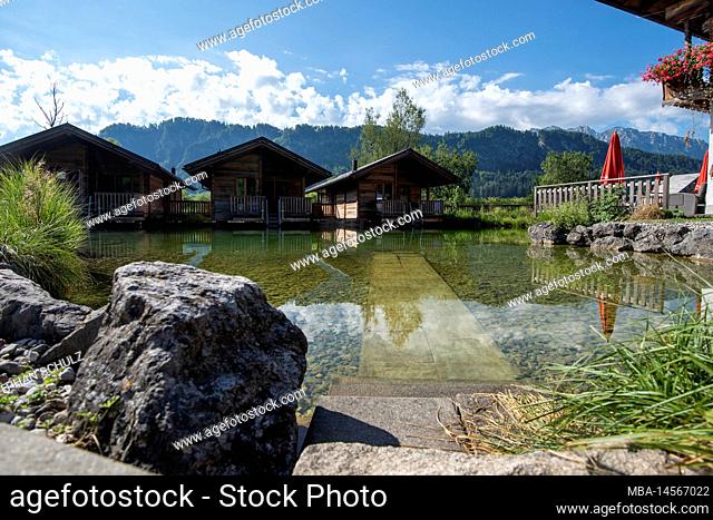 Wooden cabins by the natural pond, Golf- und Sporthotel Moarhof, Walchsee, Tyrol, Austria