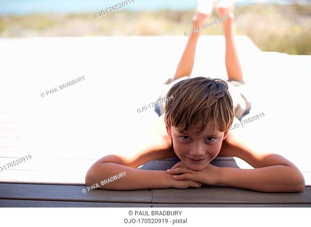 Boy relaxing on deck