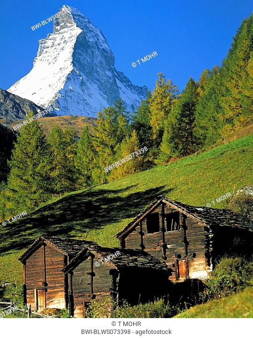 The Matterhorn in autumn, with old barns in the foreground, Switzerland