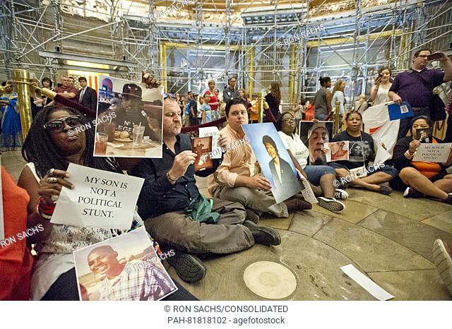Friends and family who have lost loved ones to gun violence stage a sit-in in the rotunda of the U.S. Capitol Building in Washington