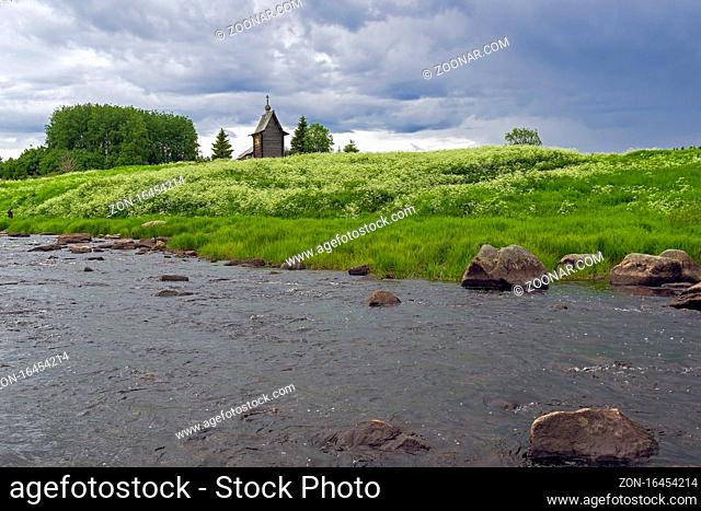 Wooden chapel on the banks of the river Keret. At this point the Keret River flows into the White Sea. Karelia, Russia, end of June