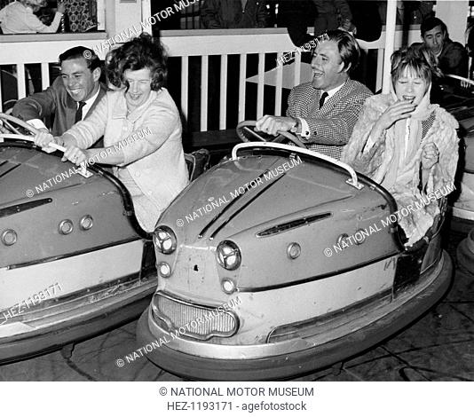 Graham Hill and Jim Clark on Dodgem cars at Butlins, Bognor Regis, 1960s. Mrs Campbell-Jones is on the Dodgem with Hill and Mrs Gregor Grant is in the one...