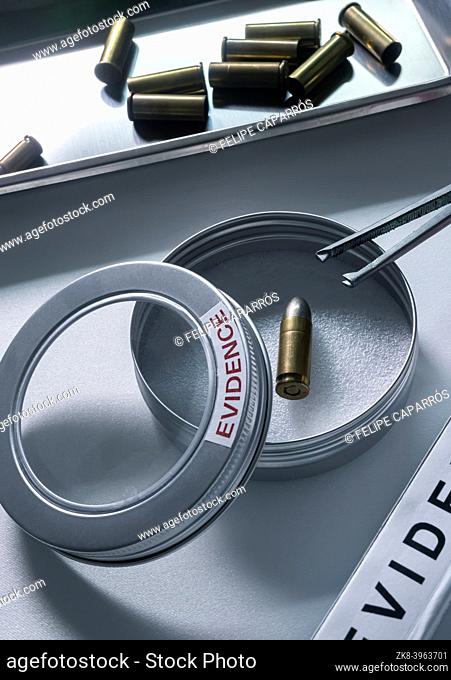 Bullet cap next to a test bag in ballistic Laboratory, conceptual image