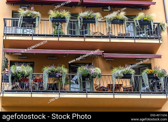 Stockholm, Sweden A pair of ornate balconies with plants on a building
