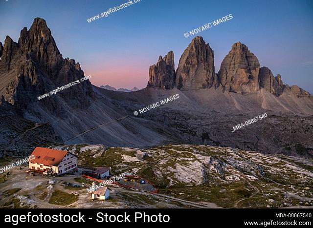 Tre Cime di Lavaredo and Triassic Hut at sunrise, Tre Cime Natural Park, Dolomites, South Tyrol, Italy