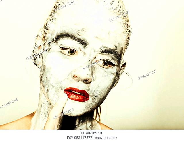 abstract art makeup. Face and neck girls smeared with gray colors and bright red lips. Holi Festival