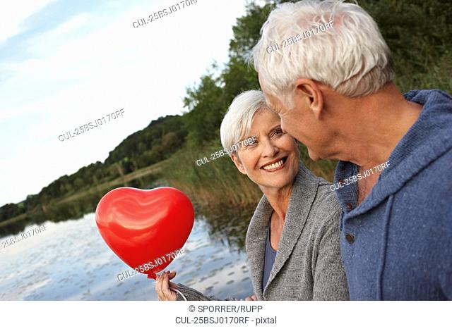 Senior couple holding red heart