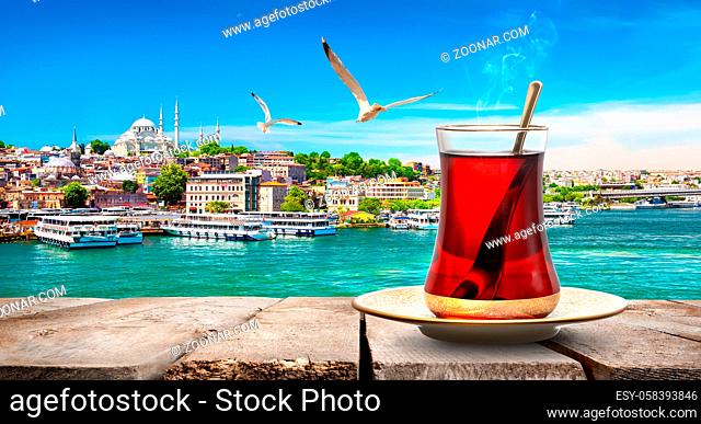 Tea in Golden Horn bay of Istanbul and view on Suleymaniye mosque, Turkey