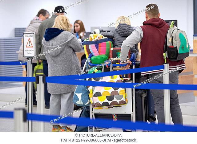 14 December 2018, Hessen, Calden: Passengers with baggage are checked in at the airport terminal at Kassel Airport. The airport in northern Hesse is the second...