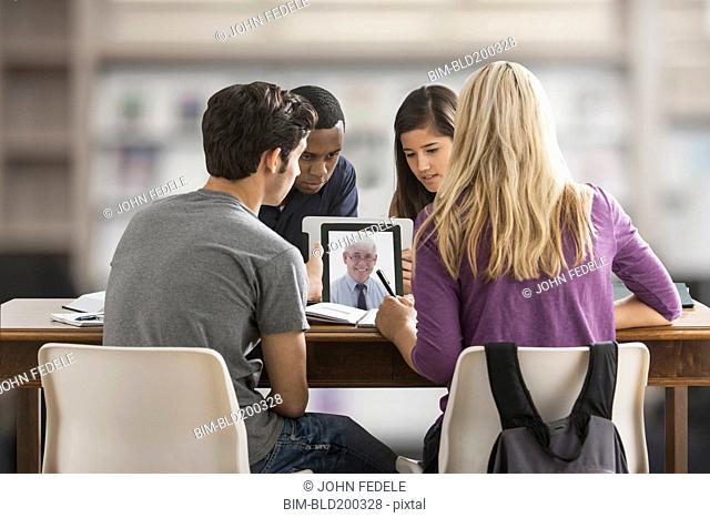 Friends studying together using digital tablet