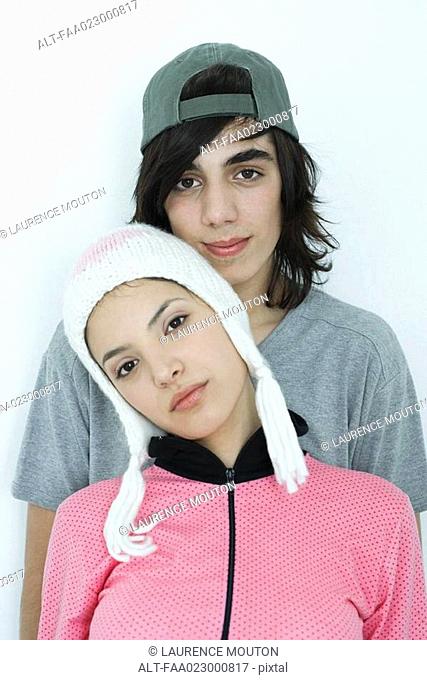 Young couple wearing hats, portrait