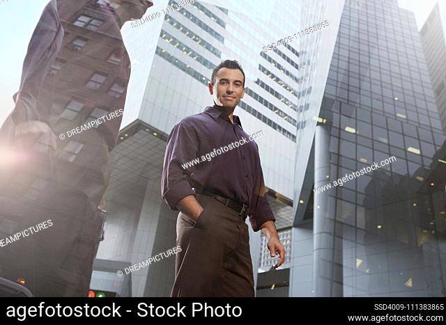 Hispanic businessman walking in urban city