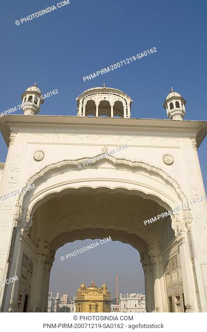 Low angle view of an archway with temple in the background, Golden Temple, Amritsar, Punjab, India