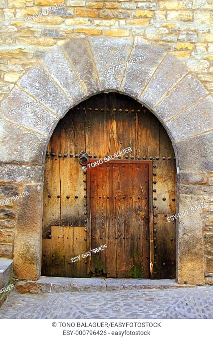 Romanesque arch door wooden medieval village of Ainsa in Spain