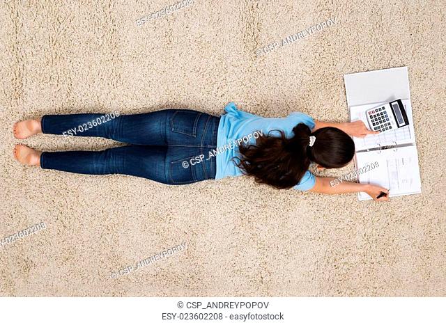 Woman On Carpet Calculating Finance