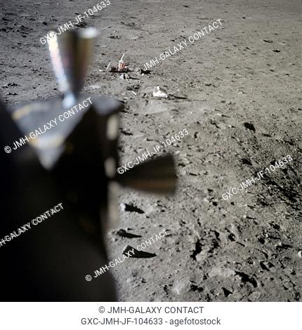 Two components of the Early Apollo Scientific Experiments Package (EASEP) are seen deployed on the lunar surface in this view photographed from inside the Lunar...