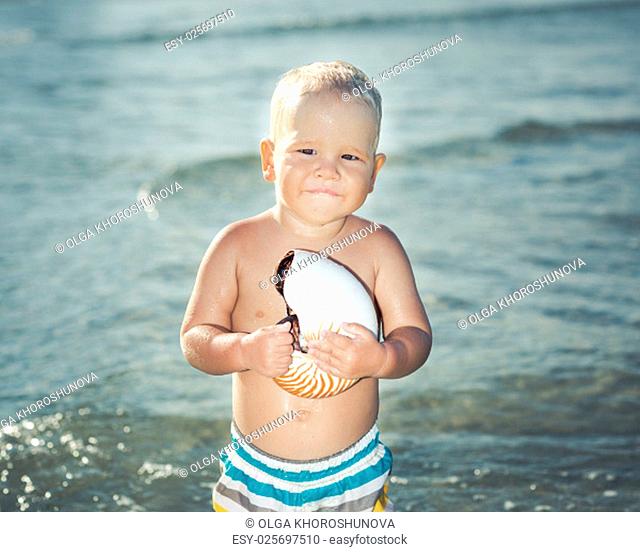 Cute baby plays in a sea