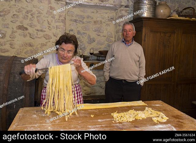 A senior woman is making fettuccine in Pettino, a small village in the mountains near Campello sul Clitunno in the Province of Perugia, Umbria, central Italy