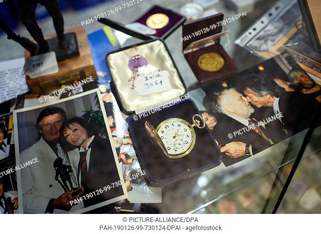 26 January 2019, Berlin: A pocket watch by the film actor Pierre Brice lies between old photos during an auction of the actor's private archive in the Historia...