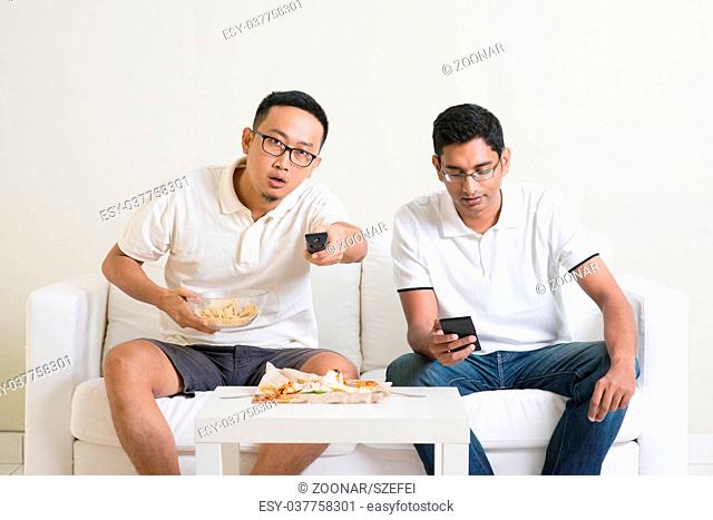 Men friends watching sport game on tv together