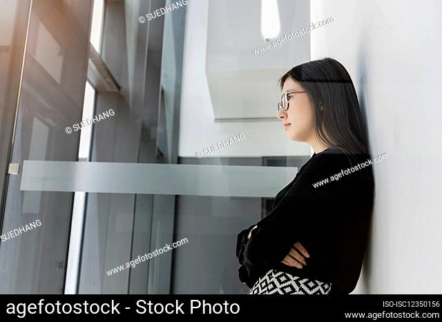 Germany, Bavaria, Munich, Young businesswoman standing in office