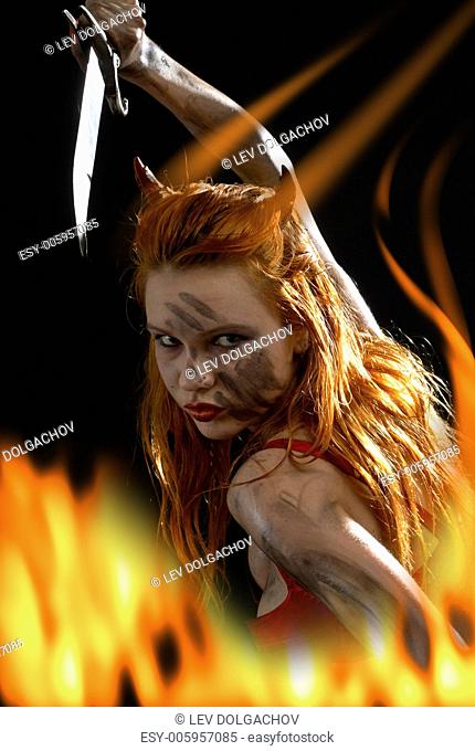 dark red devil girl with a knife in fire