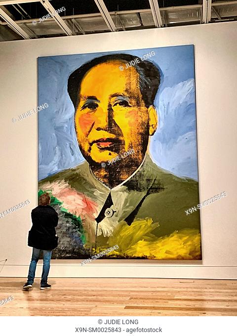 Man Admiring Andy Warhol's Chairman Mao Painting. New York, NY, USA