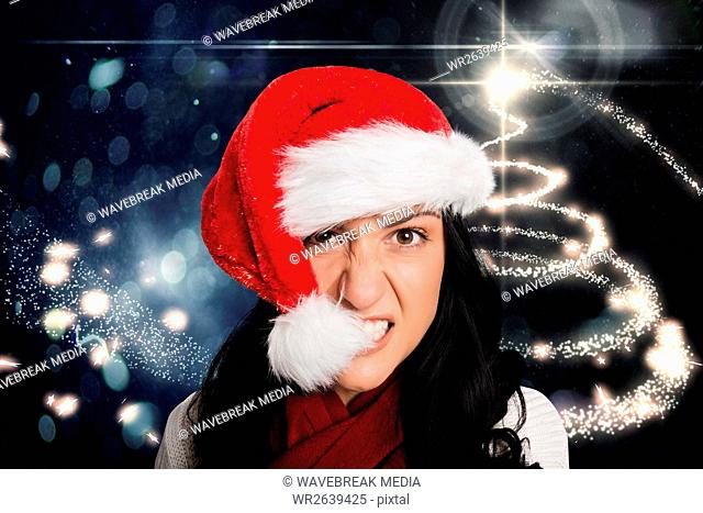Frustrated woman biting santa hat
