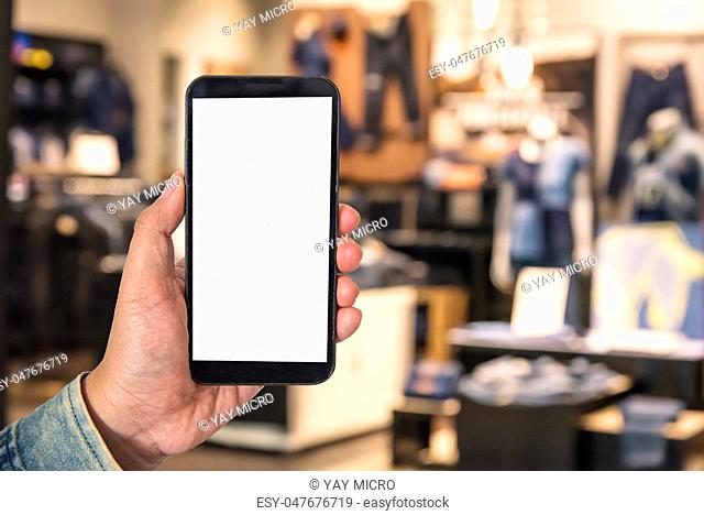 Mock up Blank screen smartphone in shopping mall background of blur background blurred indoors for lifestyle concept or co-working background